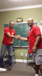 owner lori allen shaking hands with one of his employees