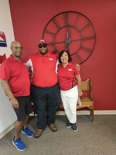 owners lori and tracy allen posing with fish employee