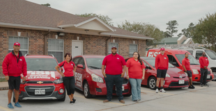 fish employees standing next to their fish window cleaning vehicles
