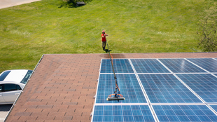 Aerial Image of Fish Window Cleaner Cleaning Solar Panels with Water-Fed Pole