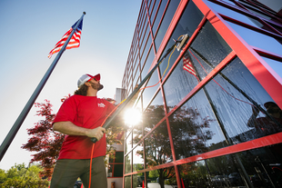 Image of Fish Window Cleaner Using Water-Fed Pole to Clean Building Windows