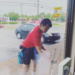 owner jerrel ngo cleaning windows of a building