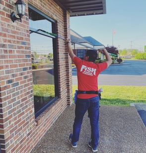 window cleaner cleaning windows of a building