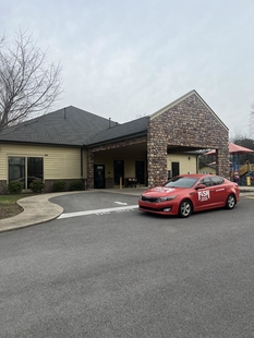 red fish window cleaning car parked in front of special kids therapy and nursery center