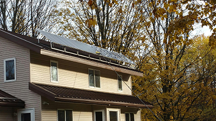 Waterfed pole cleaning solar panels on a residential home