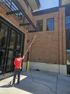 window cleaner cleaning windows of new fire department building