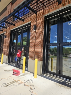 window cleaner cleaning windows of new fire department building