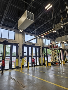 window cleaners cleaning interior side of windows at new fire department building