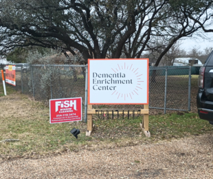 fish window cleaning sign next to the dementia enrichment center sign