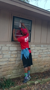 window cleaner cleaning window of a building