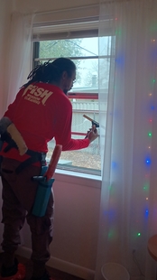 window cleaner cleaning the interior window of a house